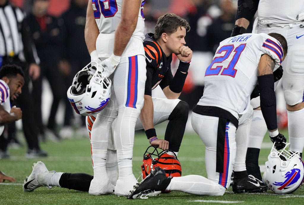 Joe Burrow #9 of the Cincinnati Bengals and Jordan Poyer #21 of the Buffalo Bills react following the injury of Damar Hamlin #3 during the first quarter at Paycor Stadium on January 02, 2023 in Cincinnati, Ohio.