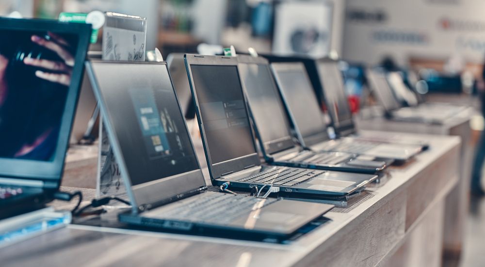 Multiple new laptops placed on a desk