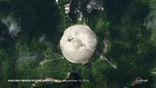 This satellite image of the Arecibo observatory shows how its dish has been torn, with green vegetation visible underneath. 