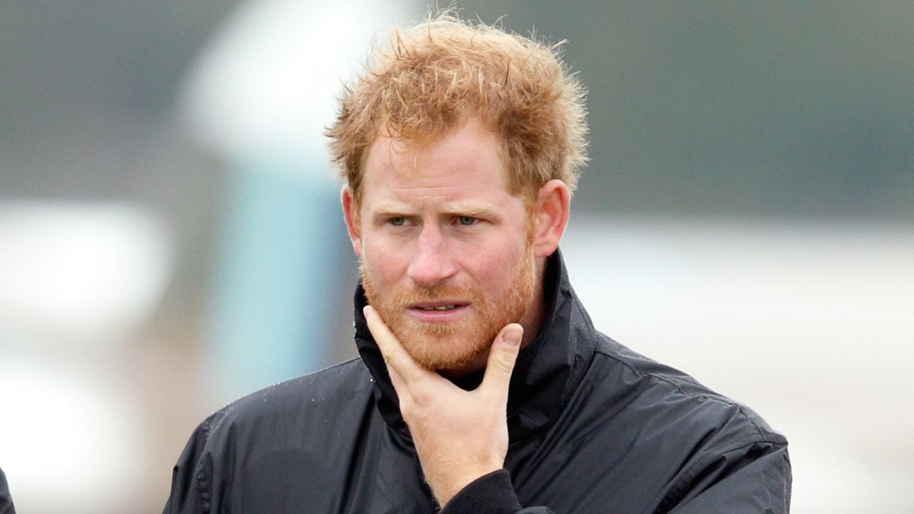 Prince Harry walks on the airfield at Goodwood Aerodrome as he is shown Spitfire Aircraft that will take place in a Battle of Britain Flypast at Goodwood on September 15, 2015 in Chichester, England