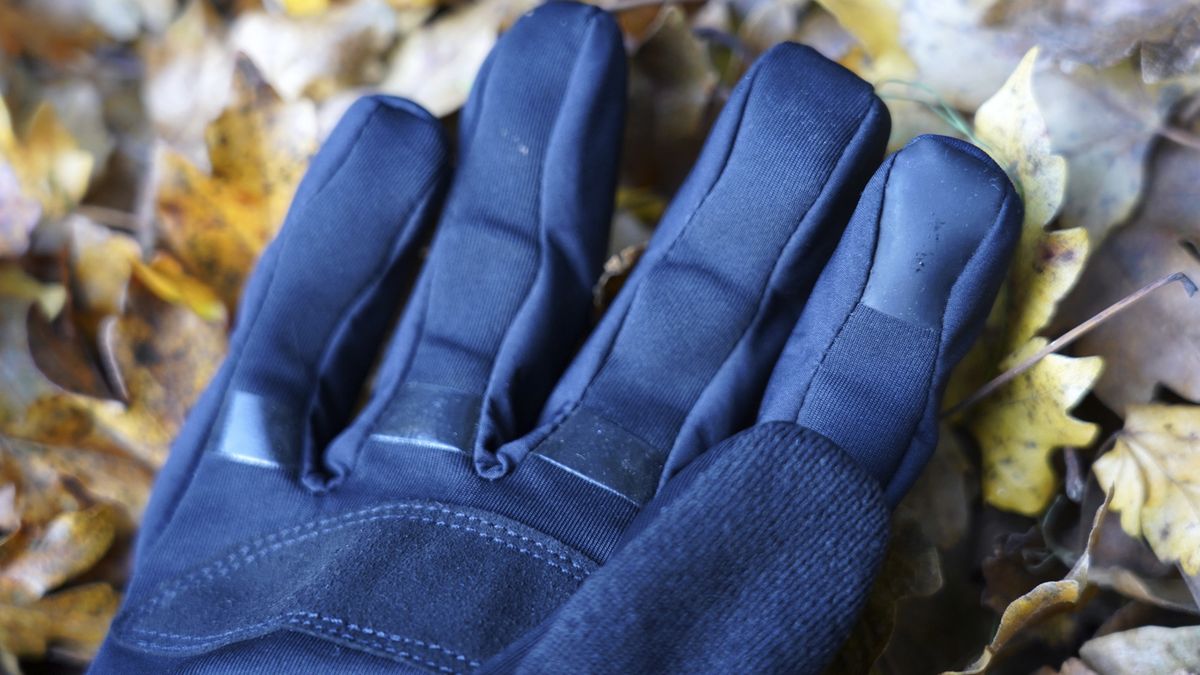 A close up of a Gore Windstopper Thermo glove on leafy ground