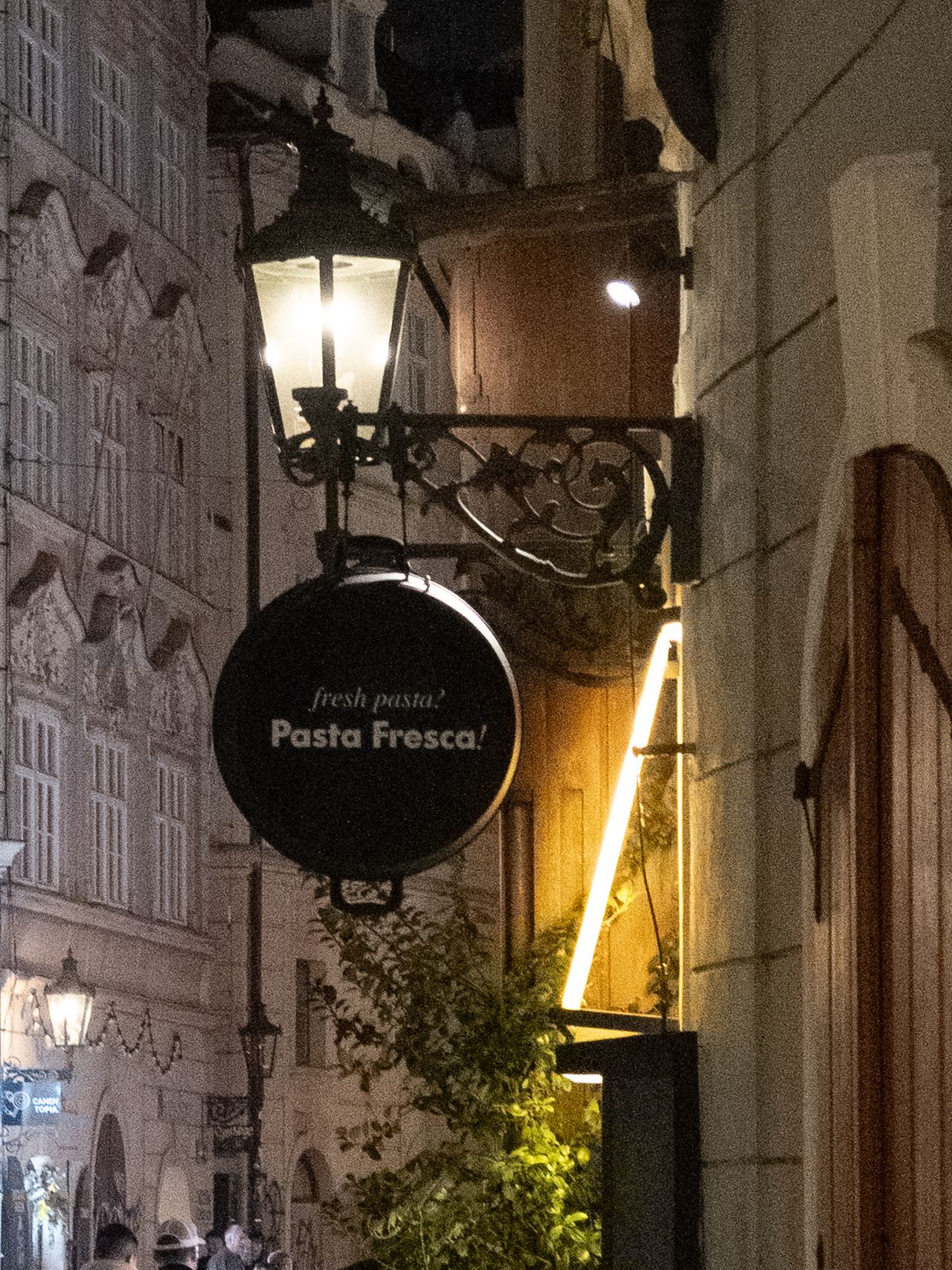 Close-up of a sign for a restaurant lit up at night