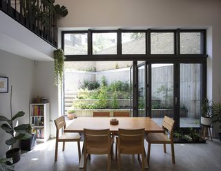 dining space looking out to garden in stepped house by vppr