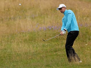 Henrik Stenson hitting a chip shot towards the green