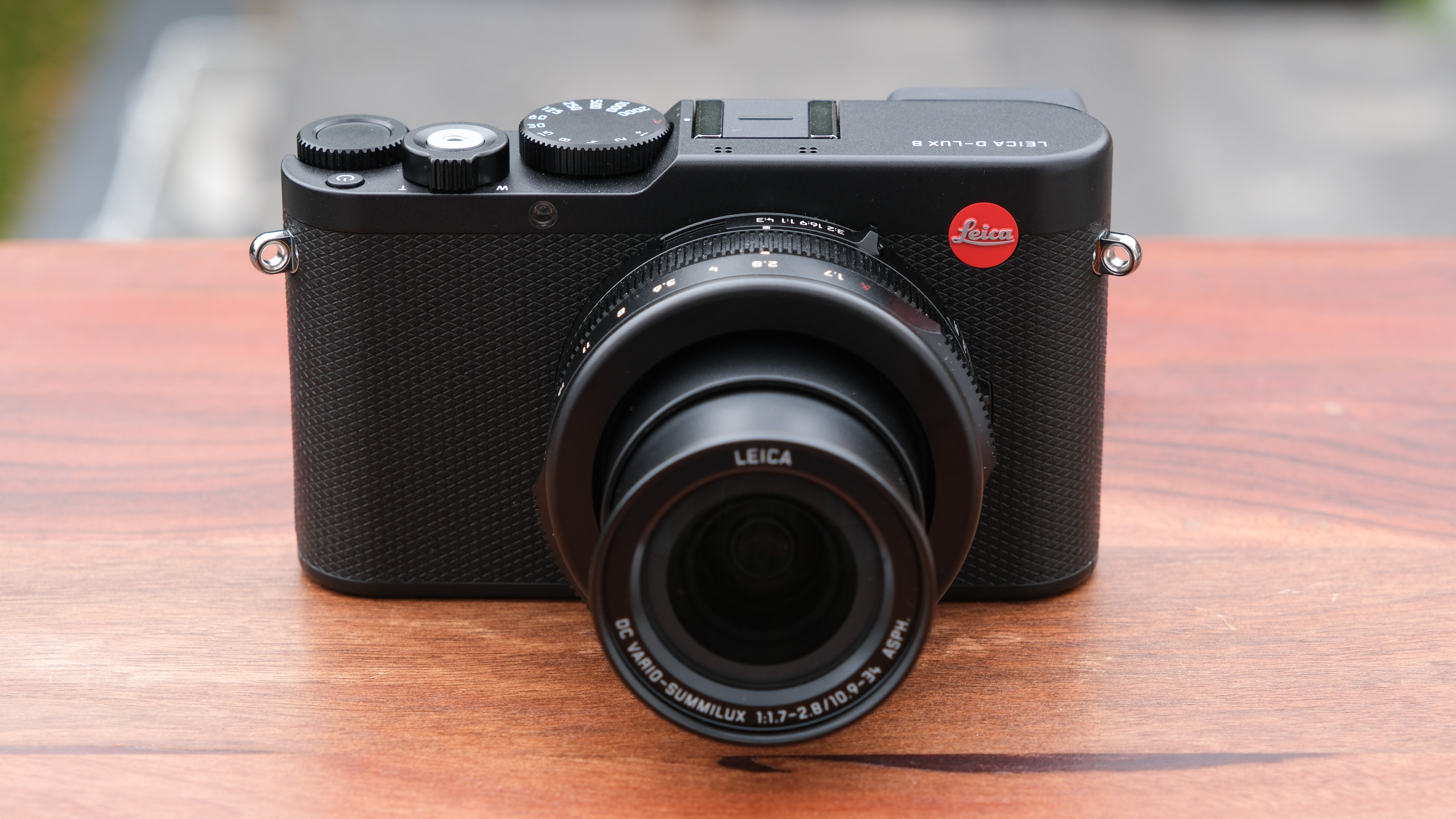 Leica D-Lux 8 camera on a wooden surface