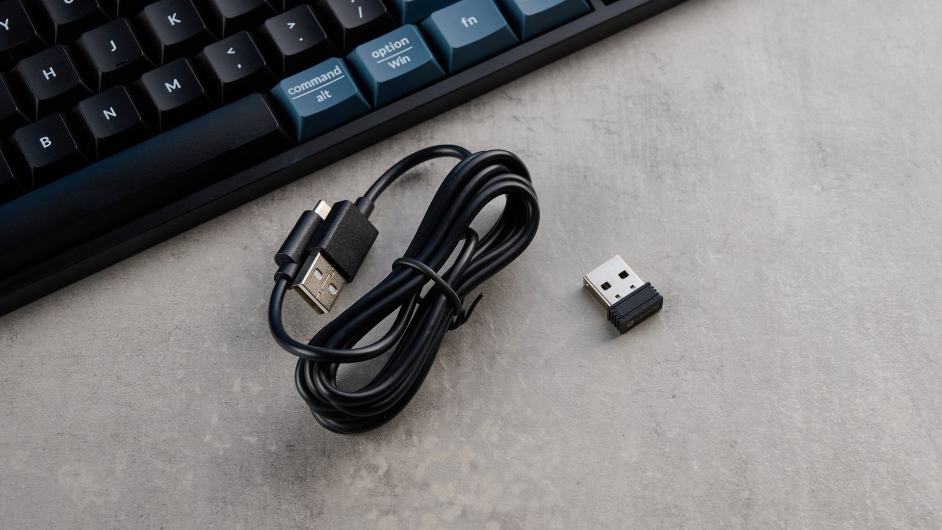 Keychron B36 keyboard and Keychron BM25 mouse photographed in front of a blue background.