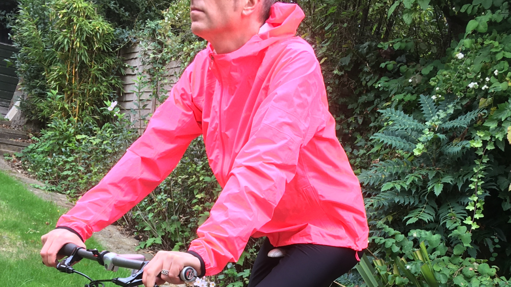Image shows a rider wearing the Rapha's Men's Commuter Lightweight Jacket which is one of the best commuter cycling jackets