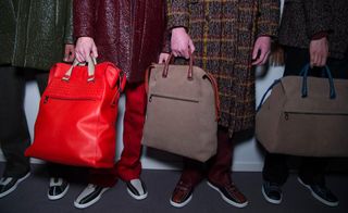 Close up of 3 duffel bags held by the models