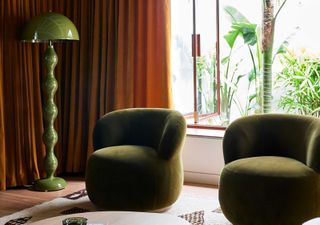 a living room with rust red curtains