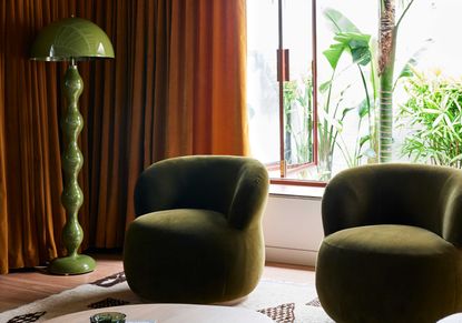 a living room with rust red curtains