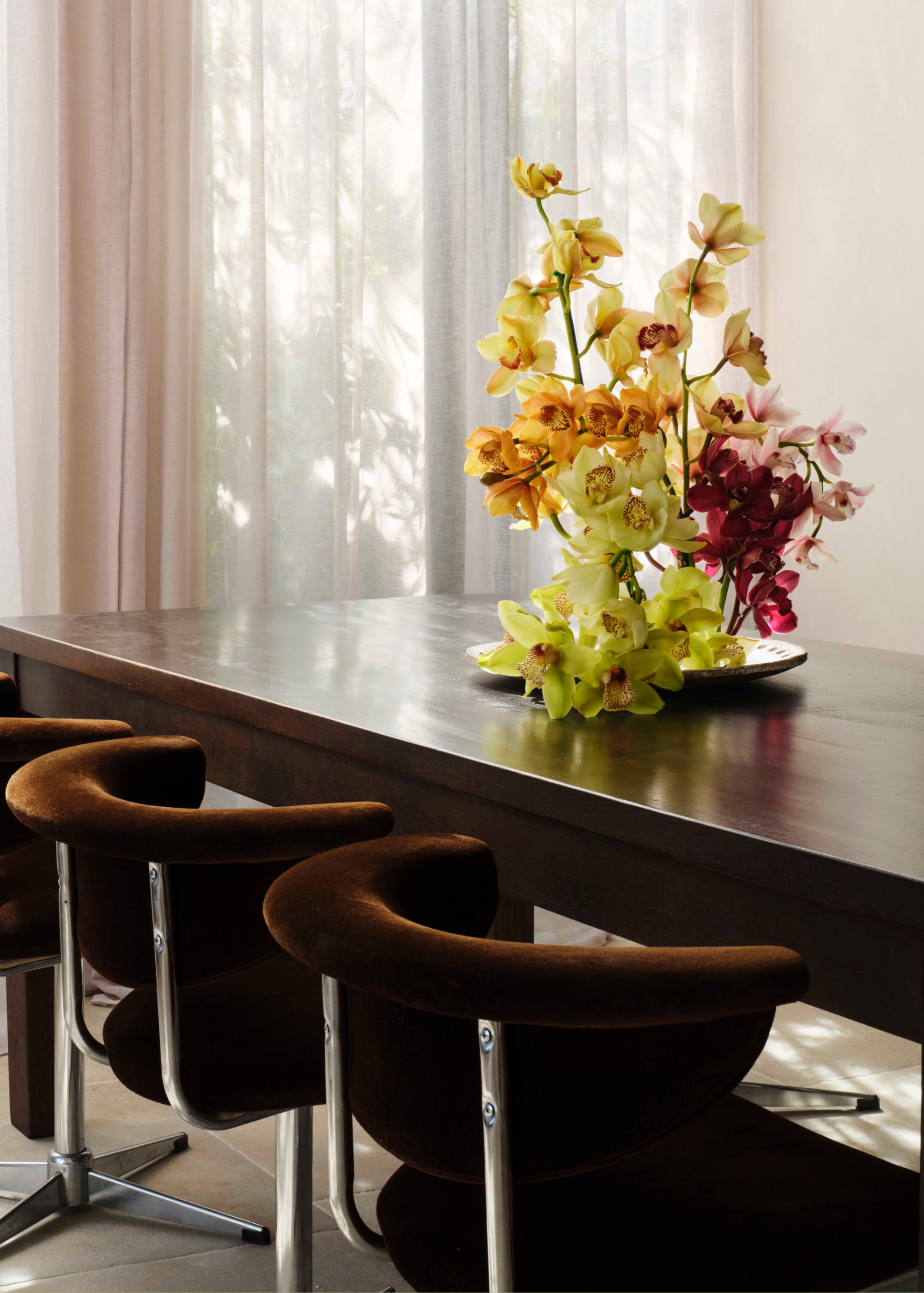A table centrepiece with colorful orchids