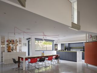 Station Lodge is an unusual London house with a huge gray pitched roof and red stairs