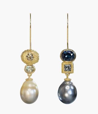 Grey and white pearl earrings with precious stones.