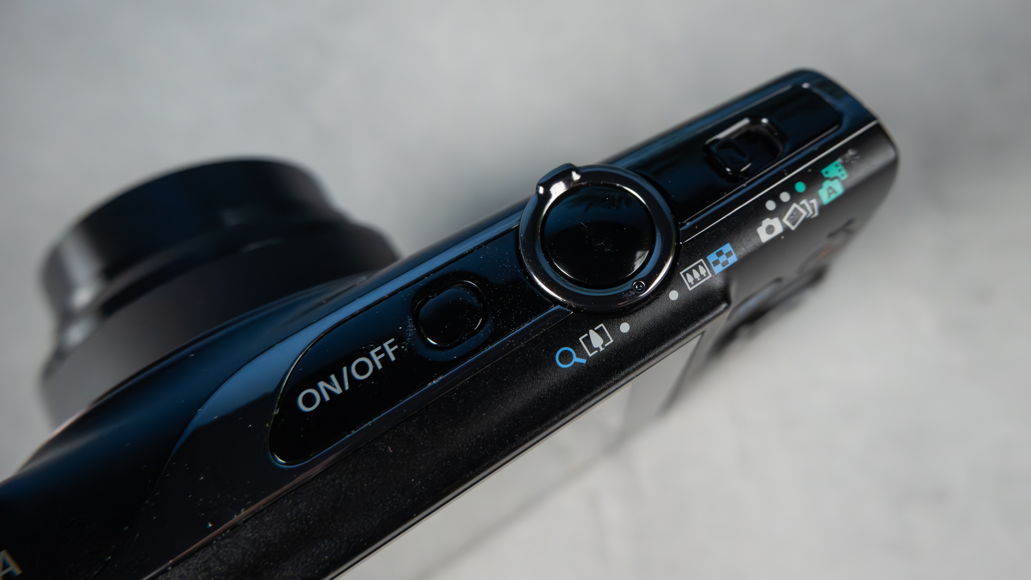 A black Canon PowerShot Elph 360 HS A or Canon PowerShot IXUS 285 HS A compact camera