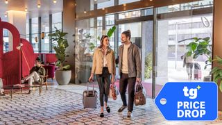 A young couple entering a Hilton hotel