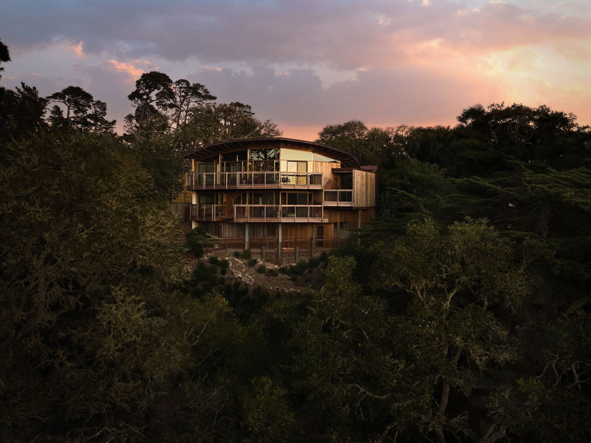 Wood and glass house amid trees
