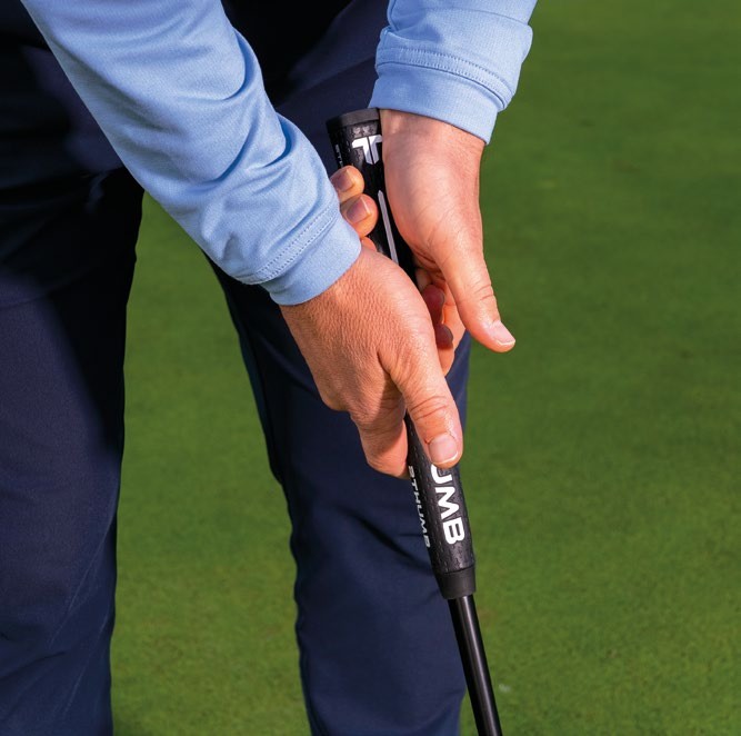 A close up of James Jankowski gripping his putter