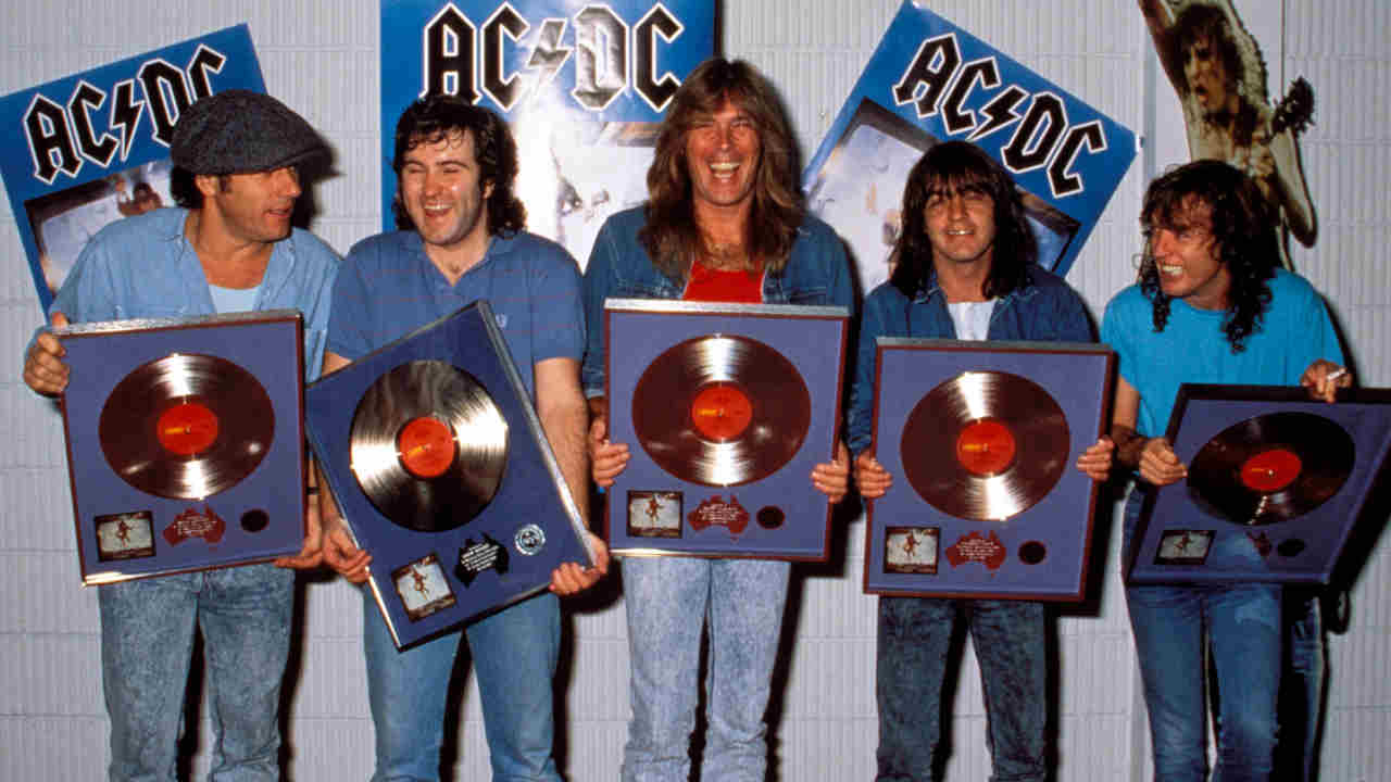 AC/DC holding silver discs in 1988