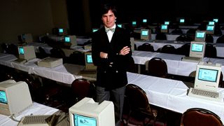 Steve Jobs pictured in a room full of computers in 1984.