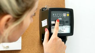 A woman reading her electricity meter