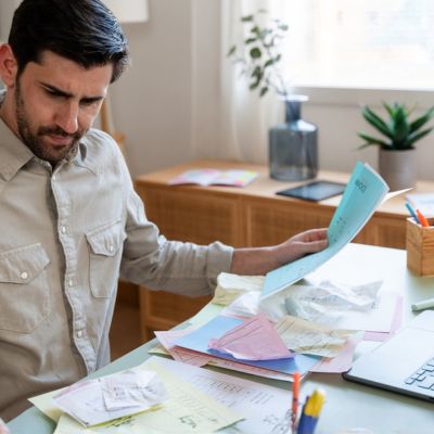 A man frustrated with his complicated home budget.