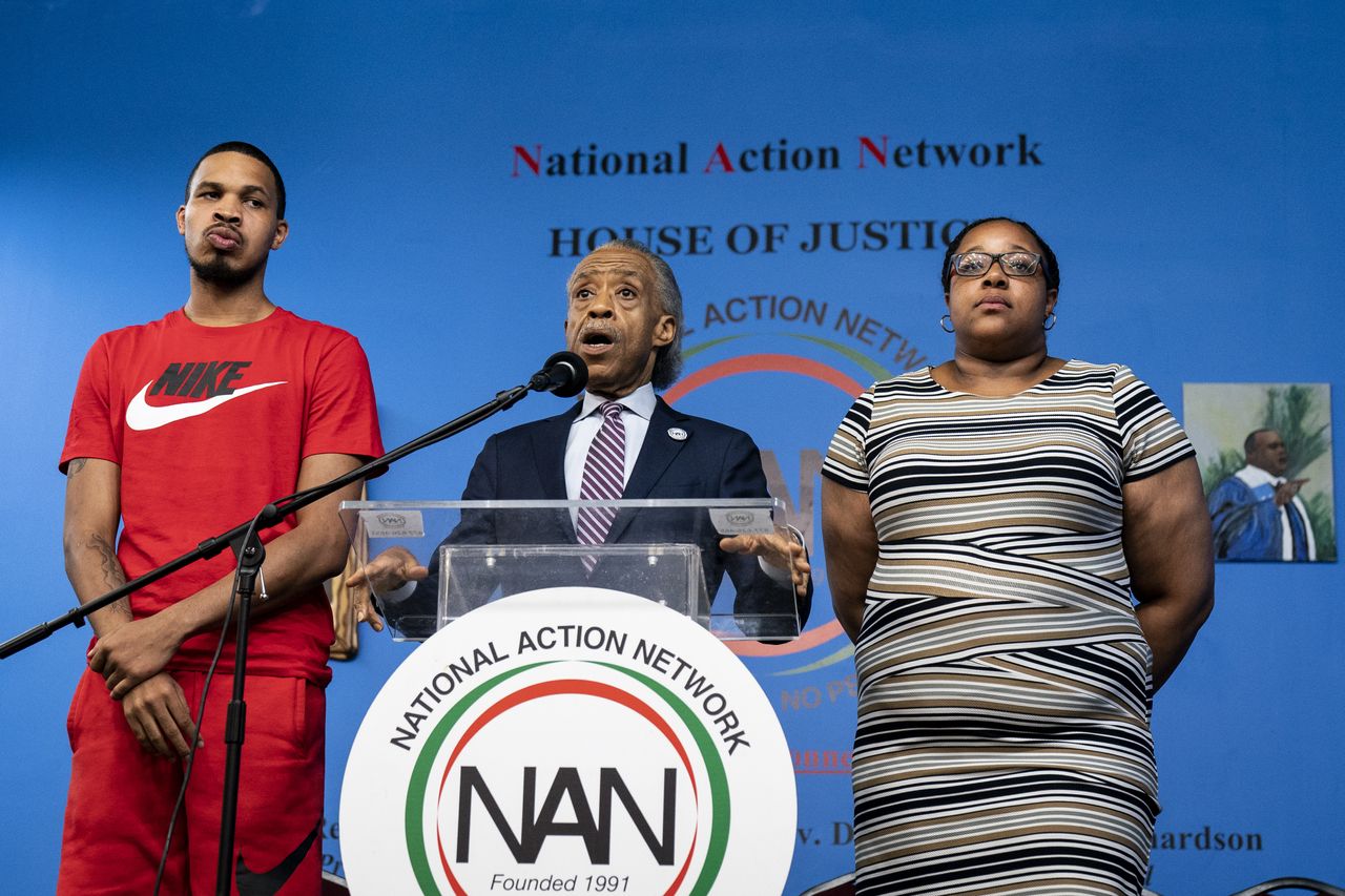 Eric Garner Jr. (L) and Emerald Garner (R), daughter of the late Eric Garner, Rev. Al Sharpton (C).