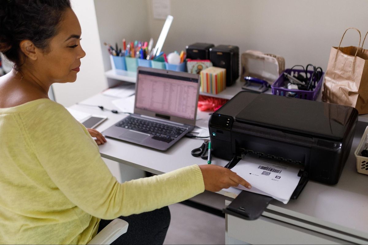 Woman printing in office