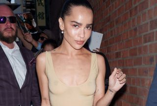 Zoe Kravitz at a screening for Blink Twice wearing a sheer Yves Saint Laurent nude bodysuit and black plisse skirt.