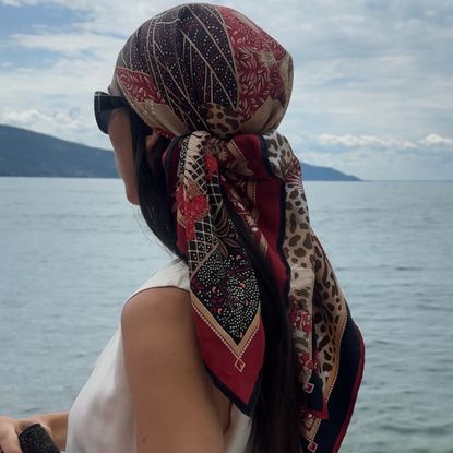Alexis Badiyi on a boat wearing a headscarf and a white shirt