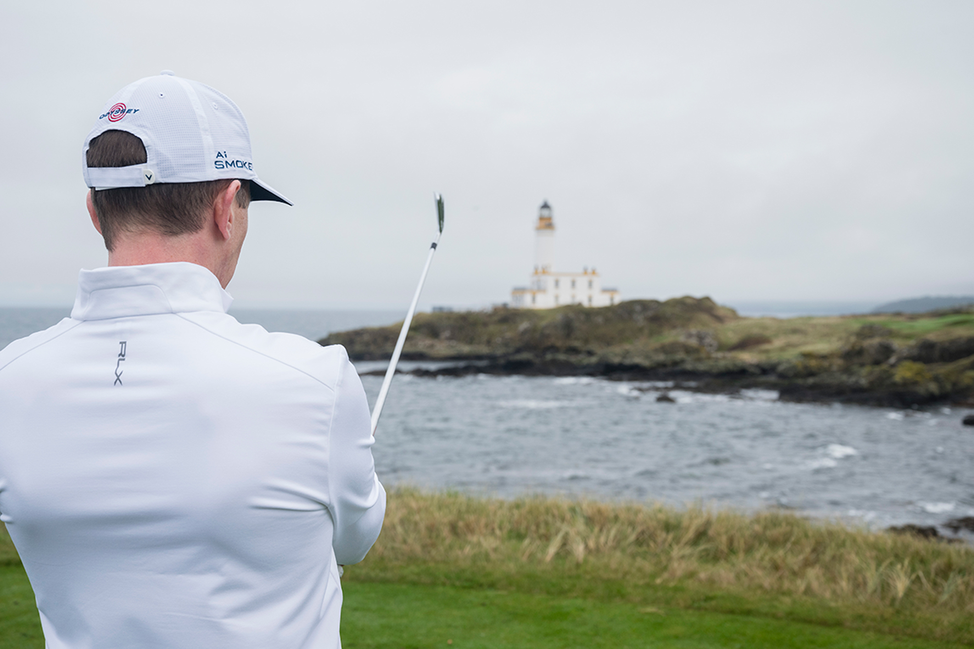 Ben Emerson lining up his next shot on the par-3 9th tee box at Trump Turnberry, in front of the famous lighthouse, aiming for the left side of the green