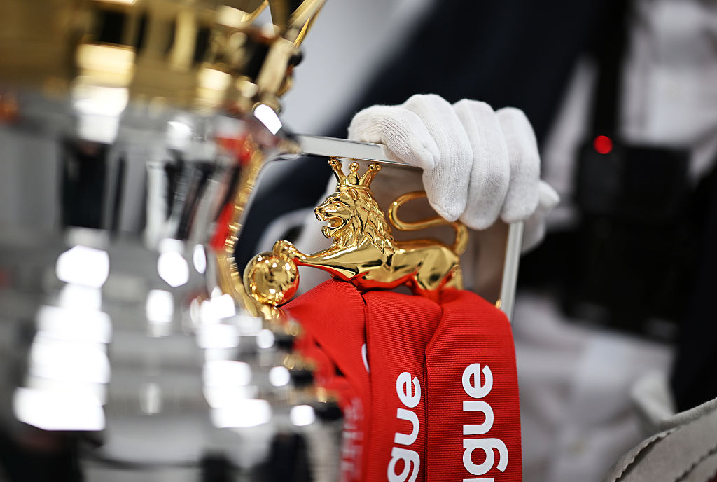  A detailed view of the golden Lion on the handle of the Premier League Trophy, as the red Premier League ribbons can be seen for Liverpool FC prior to the Premier League match between Liverpool FC and Crystal Palace FC at Anfield on May 25, 2025 in Liverpool, England.