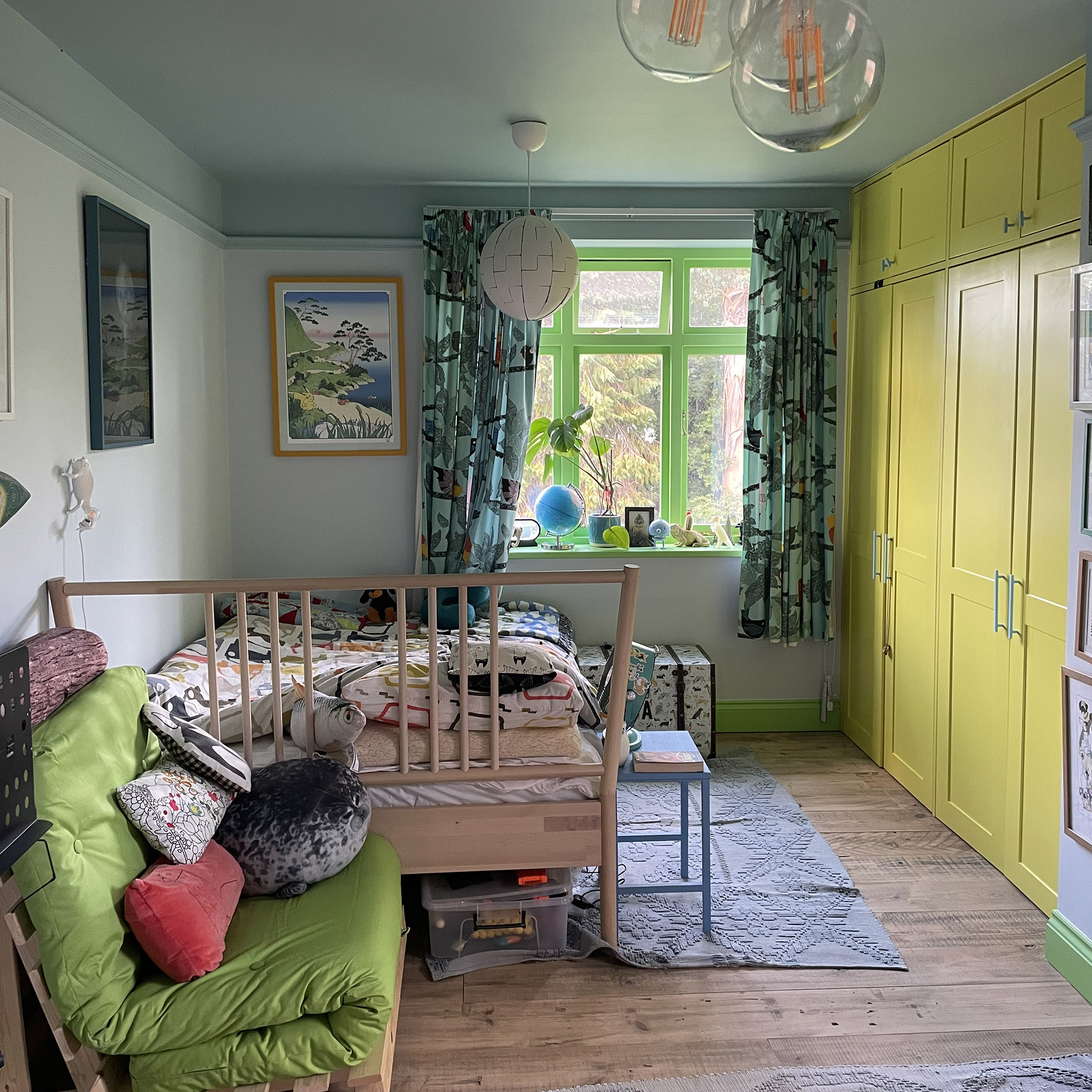 kid's room with green window frame and green couch