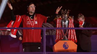 Jurgen Klopp puts on his winners medal at the Premier League trophy presentation on The Kop following the Liverpool v Chelsea Premier League match at Anfield on July 22nd 2020 in Liverpool (Photo by Tom Jenkins/Getty Images)