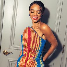 Tiffany Boone poses in front of the door to her suite wearing a Balmain x The Lion King beaded gown