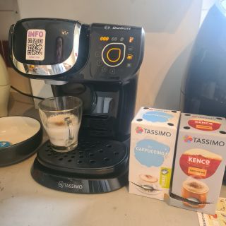 Bosch Tassimo coffee machine with milk froth in a mug