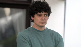 Aneurin Barnard as Ryan Wilson in The Catch, frowning and wearing a blue jumper