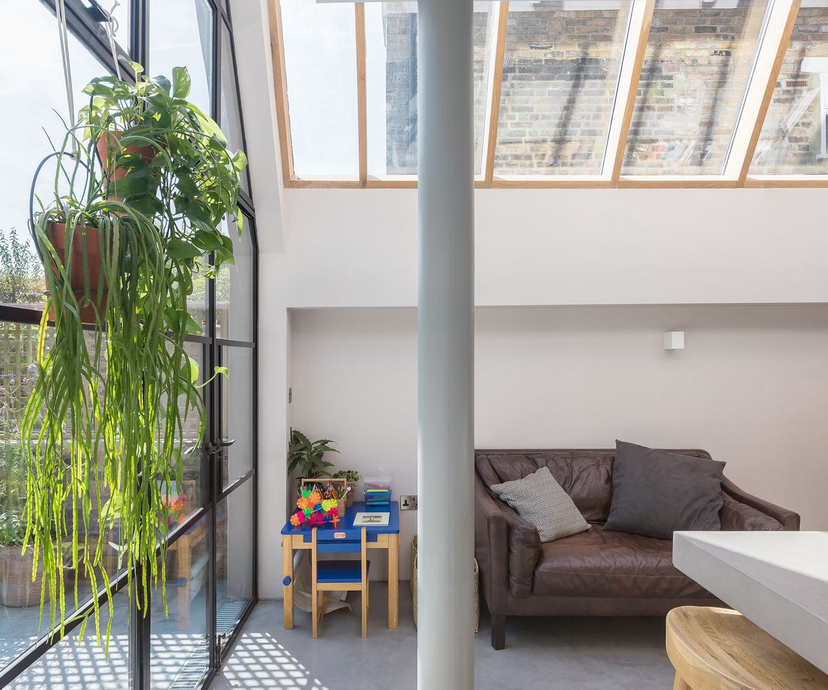 A pitched roof extension roof window with pillar and glass door and wall