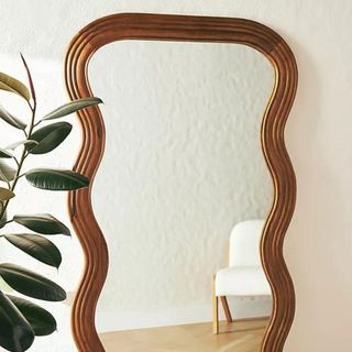 A wavy mirror with a wood frame from Anthropologie