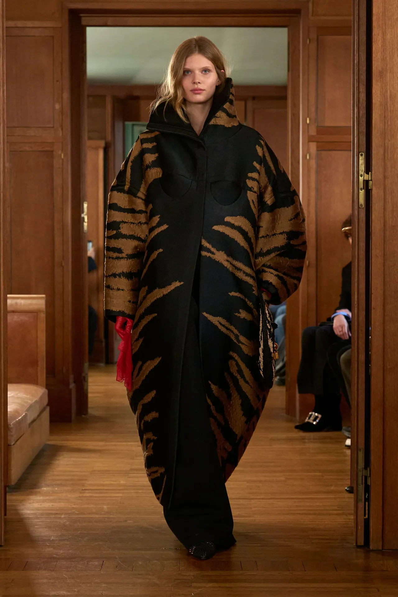 A model walking Jacquemus Spring 2025 runway wearing a tiger print coat