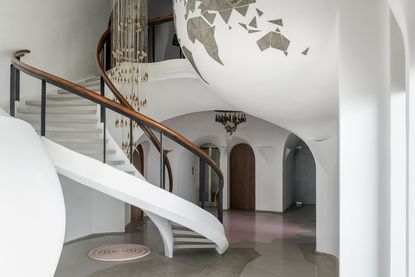 living space and curved staircase in kolkata home interior