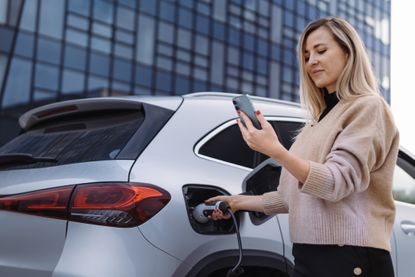 Woman waiting for her car to charge