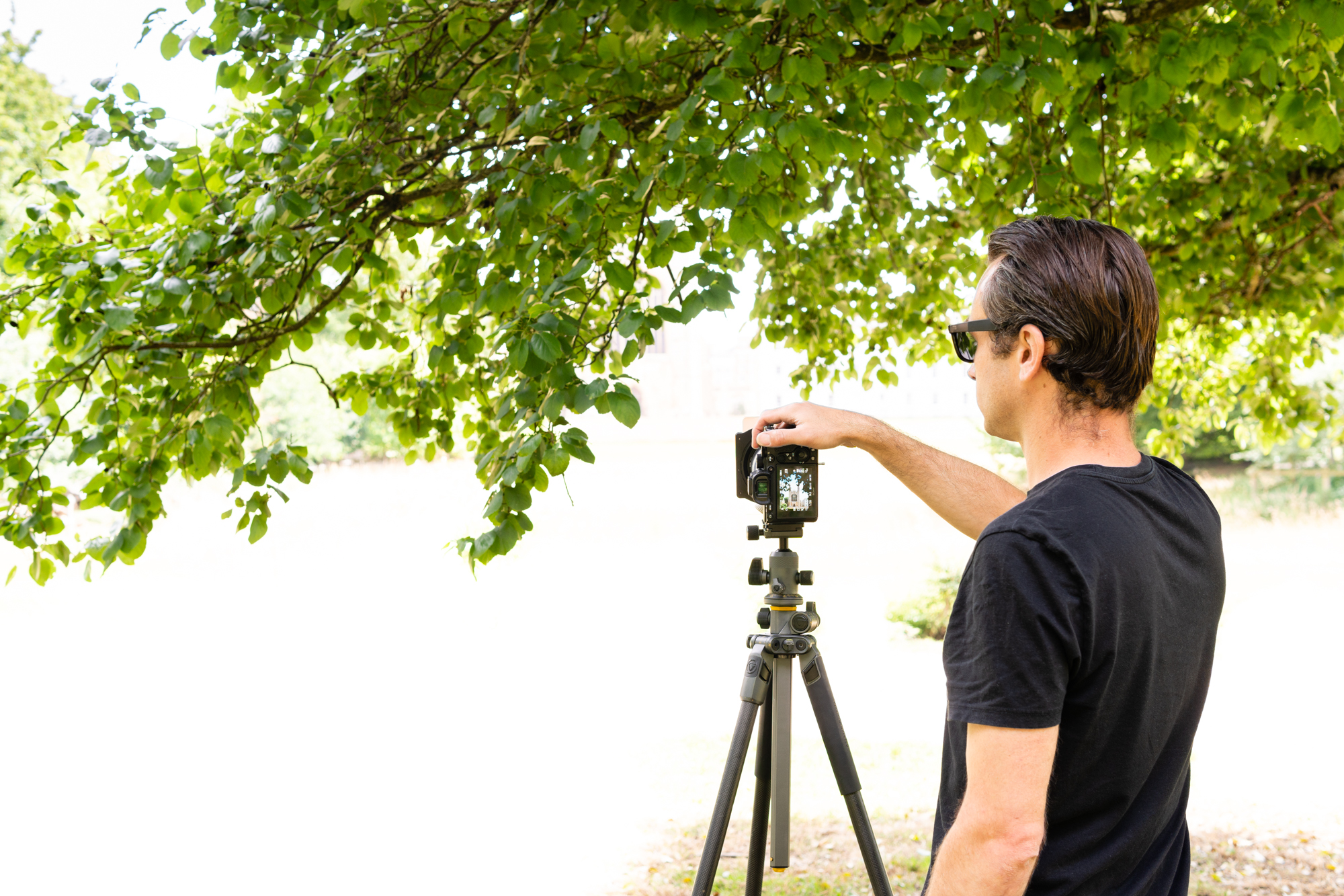 Photographer with camera on a tripod