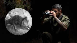 an individual holding the DVX Night Vision - Night Storm X1 with an image inside of a bear in night vision mode 