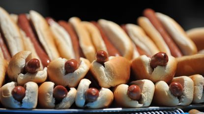 A tray of hotdogs.