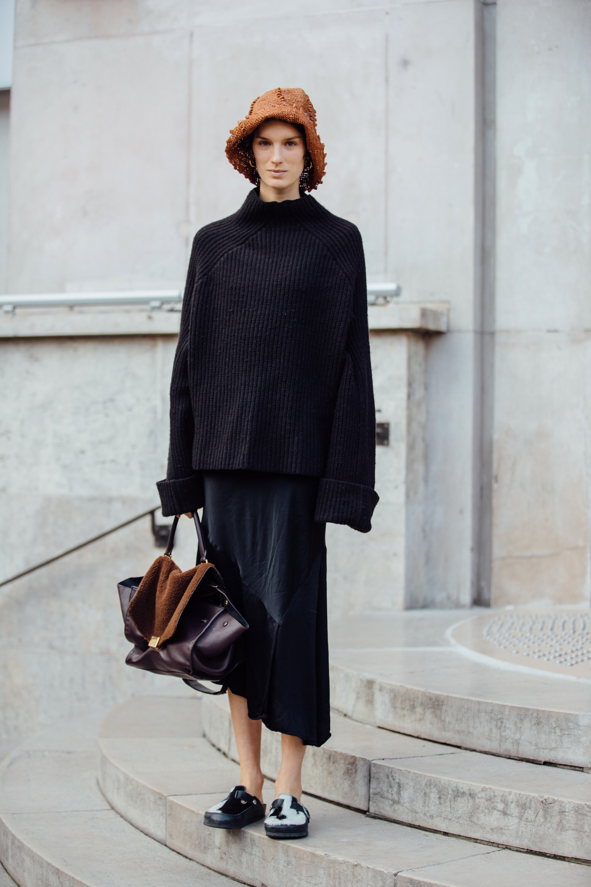 PARIS, FRANCE - SEPTEMBER 28: Model Marte Mei Van Haaster wears a brown woven hat, black knit top, black skirt, brown Celine trapeze bag, and black and white fur loafers after the Haider Ackermann show during Paris Fashion Week Spring/Summer 2020 on September 28, 2019 in Paris, France. (Photo by Melodie Jeng/Getty Images)