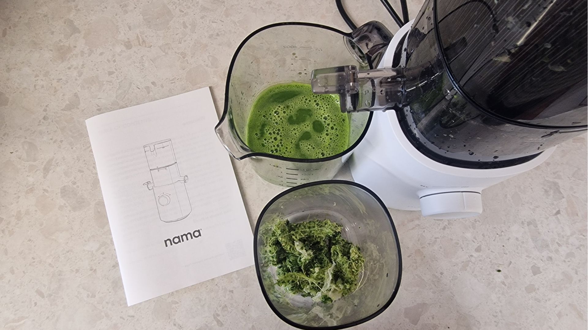 An overhead view of the green juice and pulp from the Nama J3 juicer
