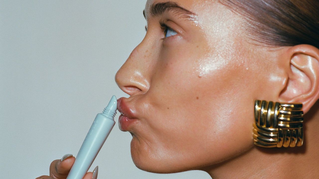 Hailey Bieber applying Rhode Peptide Lip Treatment