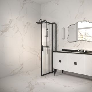 A walk-in shower with a fluted glass panel and marble effect wall and flooring