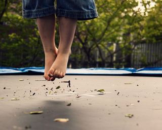 young child jumping on trampoline