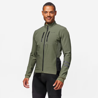 A black man in an olive green winter cycling jacket against a white background